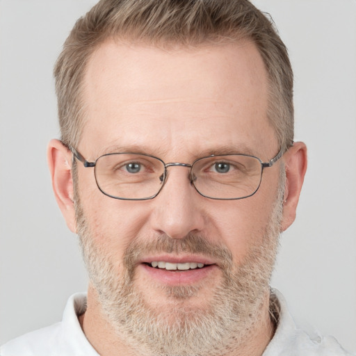 Joyful white middle-aged male with short  brown hair and grey eyes