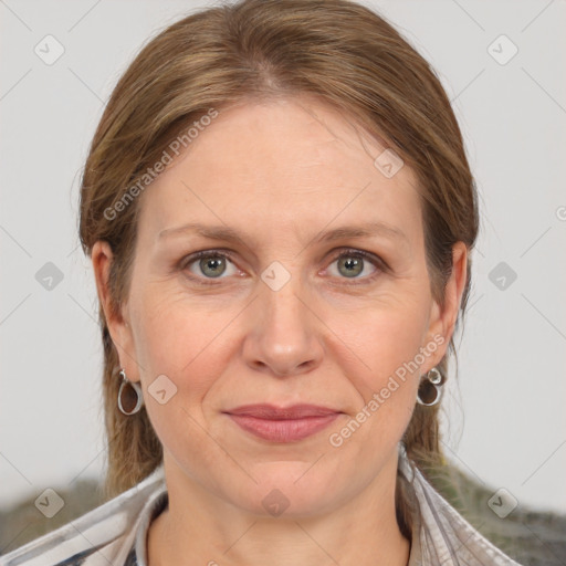 Joyful white adult female with medium  brown hair and grey eyes