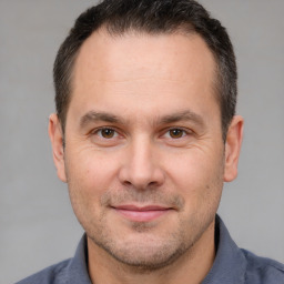 Joyful white adult male with short  brown hair and brown eyes