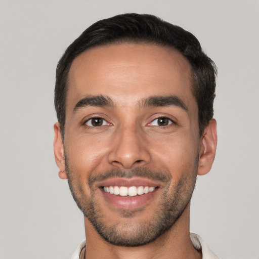 Joyful white young-adult male with short  black hair and brown eyes