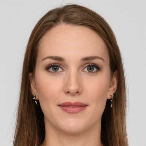 Joyful white young-adult female with long  brown hair and grey eyes