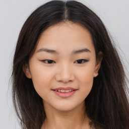 Joyful asian young-adult female with long  brown hair and brown eyes