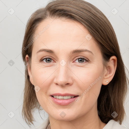 Joyful white young-adult female with medium  brown hair and grey eyes