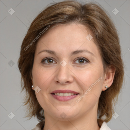 Joyful white adult female with medium  brown hair and grey eyes