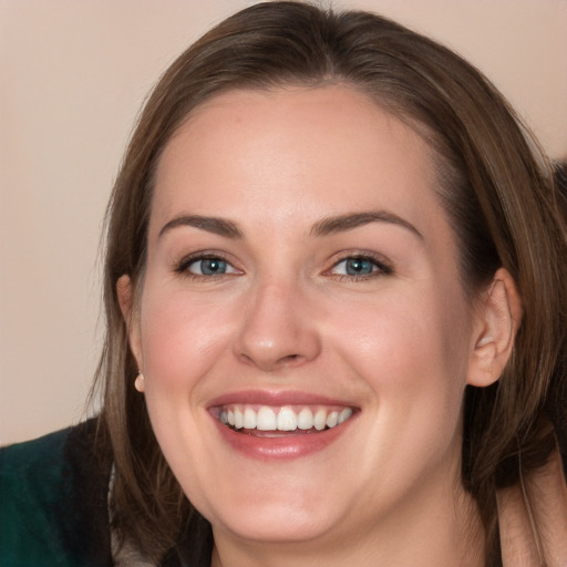 Joyful white young-adult female with long  brown hair and grey eyes