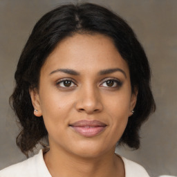 Joyful black young-adult female with medium  brown hair and brown eyes