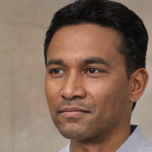 Neutral latino adult male with short  black hair and brown eyes