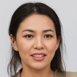 Joyful asian young-adult female with medium  brown hair and brown eyes