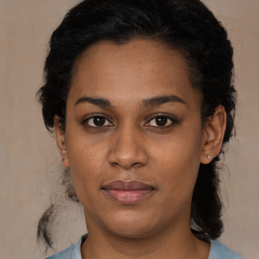 Joyful black young-adult female with medium  black hair and brown eyes