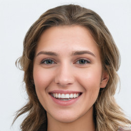 Joyful white young-adult female with long  brown hair and green eyes