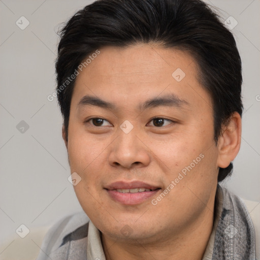 Joyful asian young-adult male with short  brown hair and brown eyes