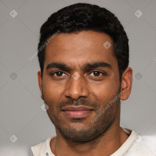 Joyful black young-adult male with short  black hair and brown eyes