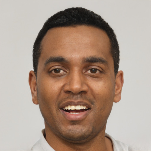Joyful black young-adult male with short  black hair and brown eyes