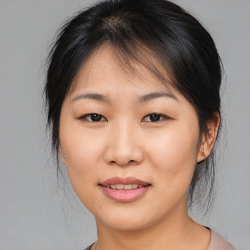 Joyful asian young-adult female with medium  brown hair and brown eyes