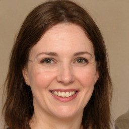 Joyful white adult female with medium  brown hair and grey eyes