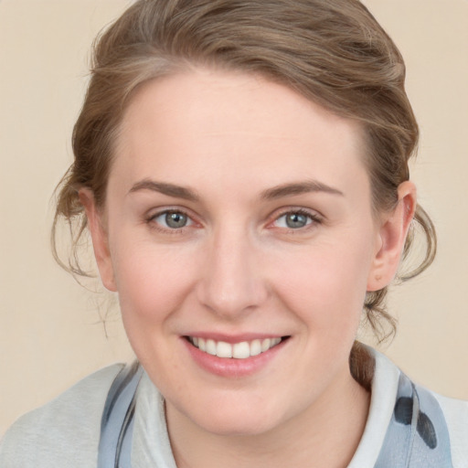 Joyful white young-adult female with medium  brown hair and blue eyes