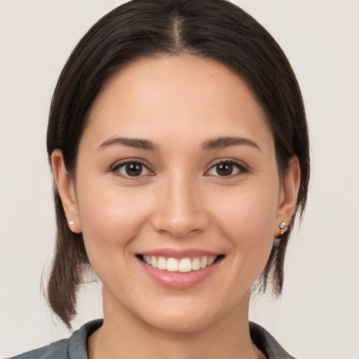 Joyful white young-adult female with medium  brown hair and brown eyes