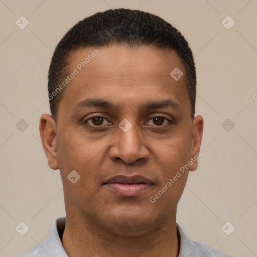 Joyful latino adult male with short  black hair and brown eyes