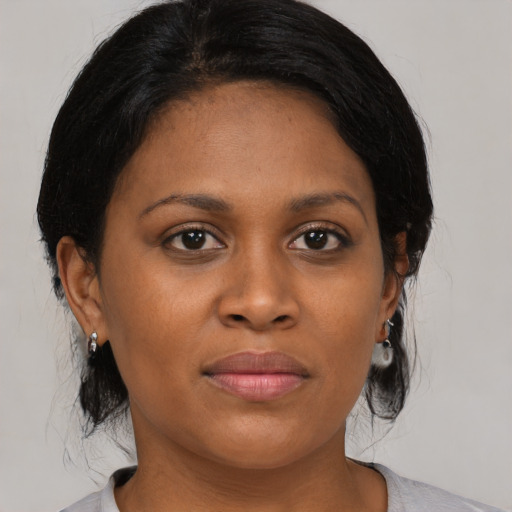 Joyful black young-adult female with medium  black hair and brown eyes