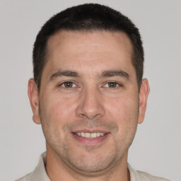 Joyful white adult male with short  brown hair and brown eyes