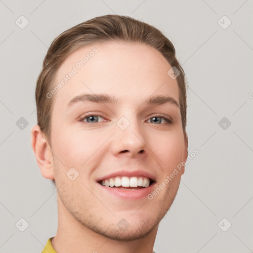 Joyful white young-adult male with short  brown hair and grey eyes