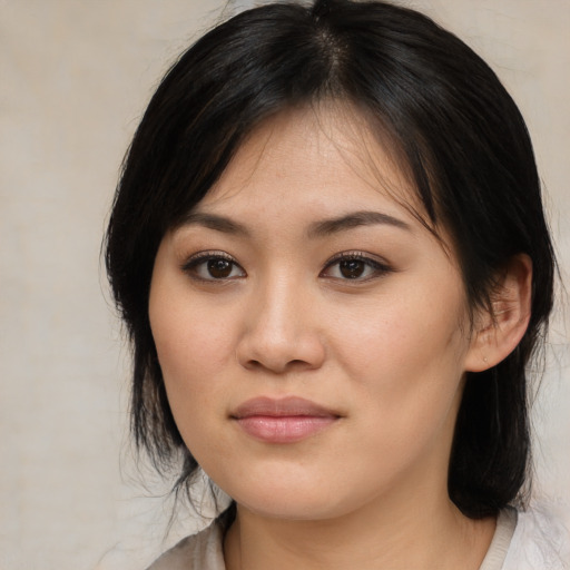 Joyful asian young-adult female with medium  brown hair and brown eyes