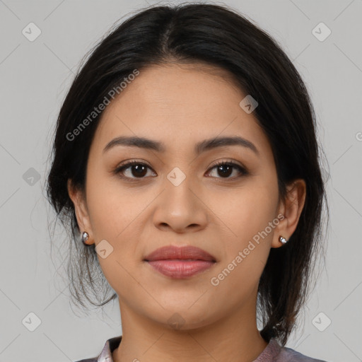 Joyful latino young-adult female with medium  brown hair and brown eyes