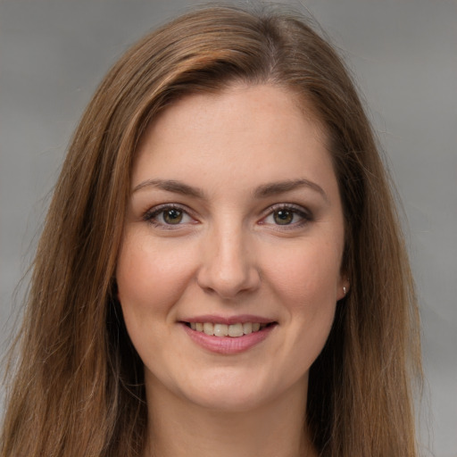 Joyful white young-adult female with long  brown hair and grey eyes