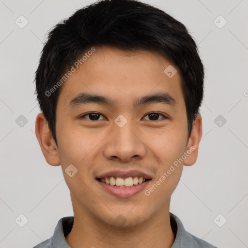 Joyful asian young-adult male with short  brown hair and brown eyes