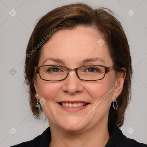 Joyful white adult female with medium  brown hair and blue eyes