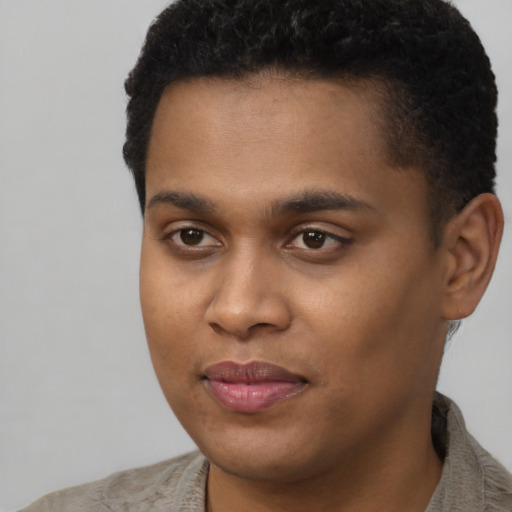 Joyful black young-adult male with short  brown hair and brown eyes