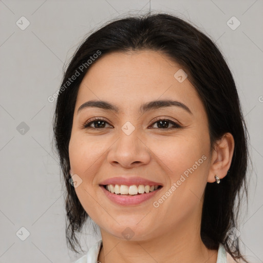 Joyful latino young-adult female with medium  brown hair and brown eyes