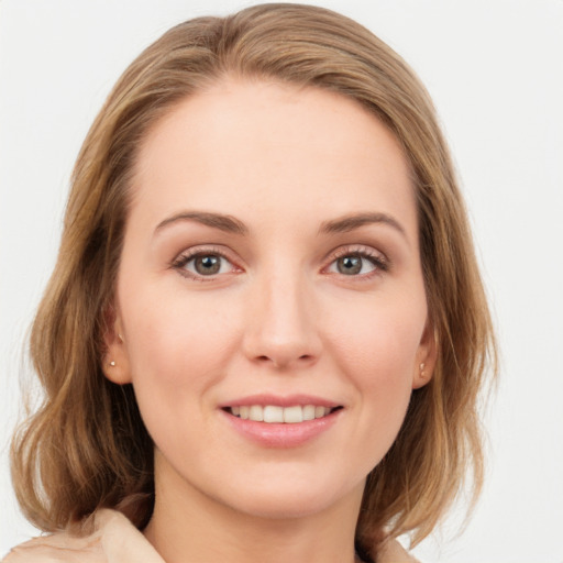 Joyful white young-adult female with medium  brown hair and blue eyes