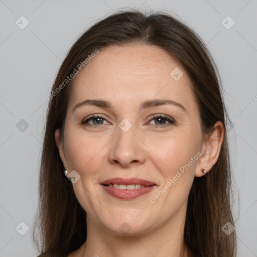 Joyful white adult female with long  brown hair and brown eyes