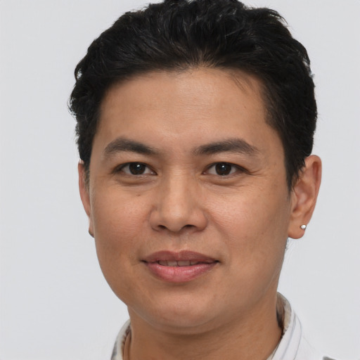 Joyful asian young-adult male with short  brown hair and brown eyes