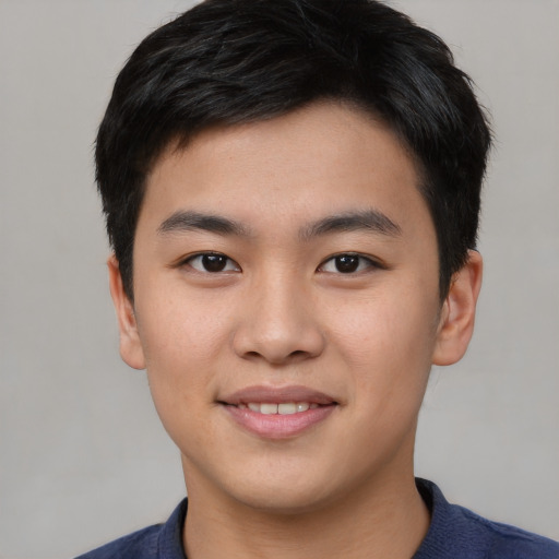 Joyful asian young-adult male with short  black hair and brown eyes