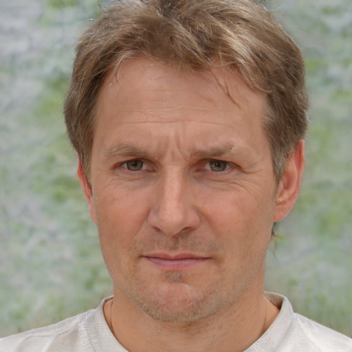 Joyful white middle-aged male with short  brown hair and brown eyes