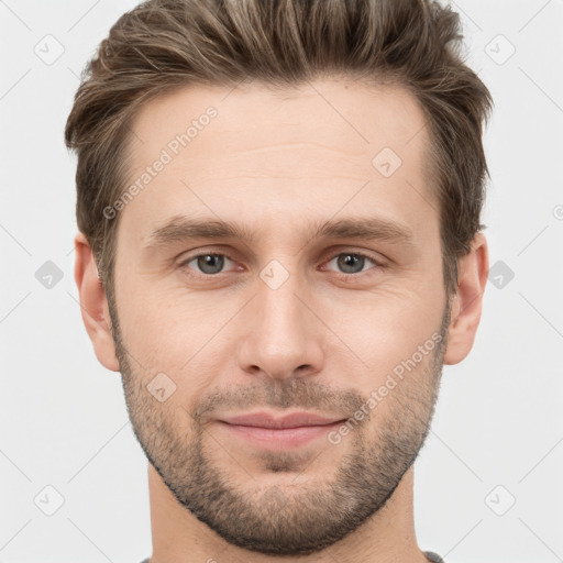 Joyful white young-adult male with short  brown hair and grey eyes