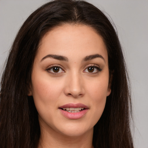 Joyful white young-adult female with long  brown hair and brown eyes