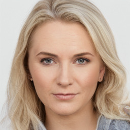 Joyful white young-adult female with long  brown hair and blue eyes