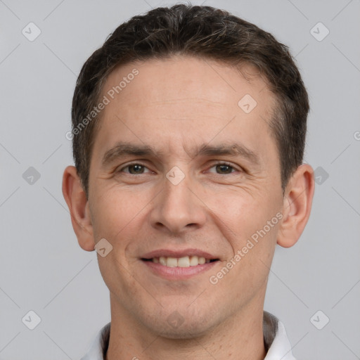 Joyful white adult male with short  brown hair and brown eyes