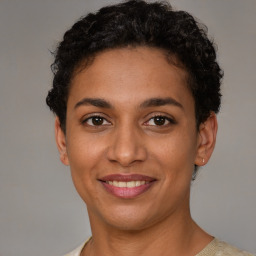 Joyful latino young-adult female with short  brown hair and brown eyes