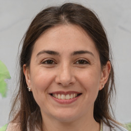 Joyful white adult female with medium  brown hair and brown eyes