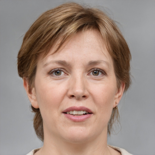 Joyful white adult female with medium  brown hair and grey eyes