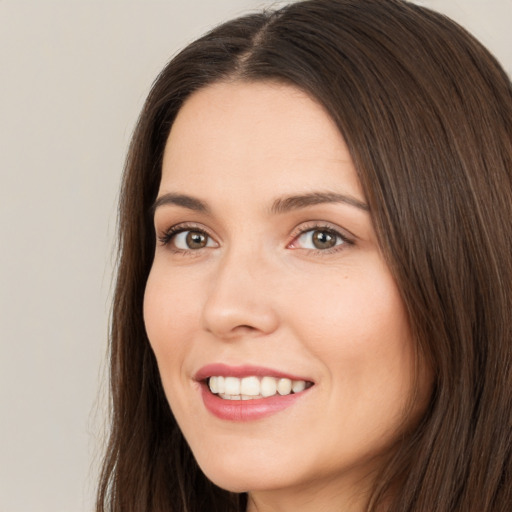 Joyful white young-adult female with long  brown hair and brown eyes