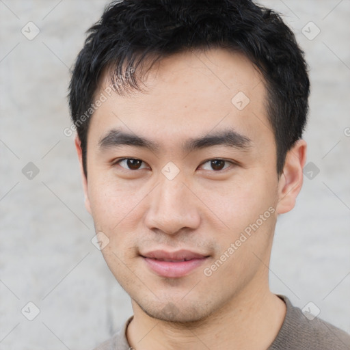 Joyful asian young-adult male with short  black hair and brown eyes