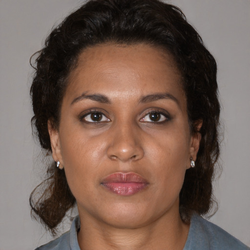 Joyful black adult female with medium  brown hair and brown eyes