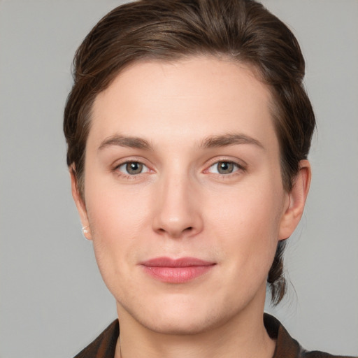 Joyful white young-adult female with short  brown hair and grey eyes