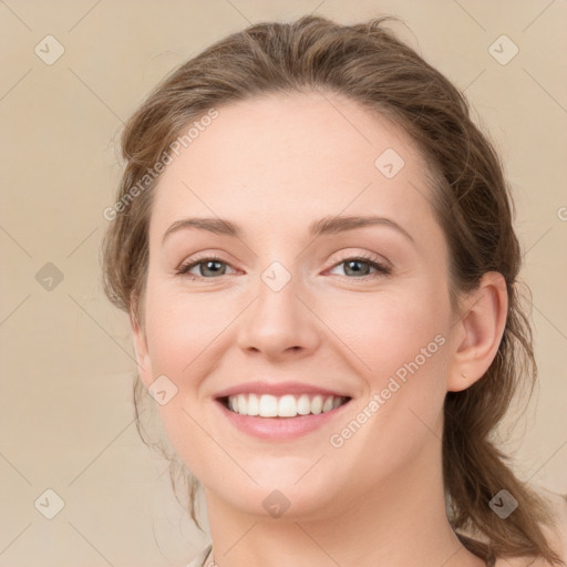 Joyful white young-adult female with medium  brown hair and green eyes