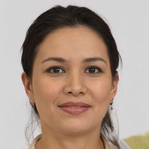Joyful latino adult female with medium  brown hair and brown eyes